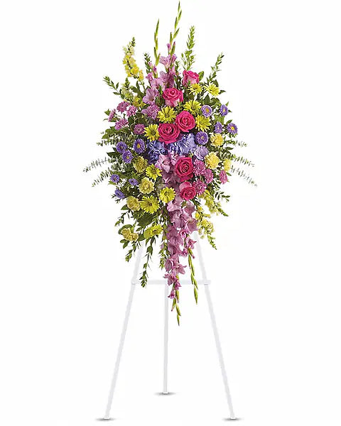 Colorful floral arrangement on a white stand