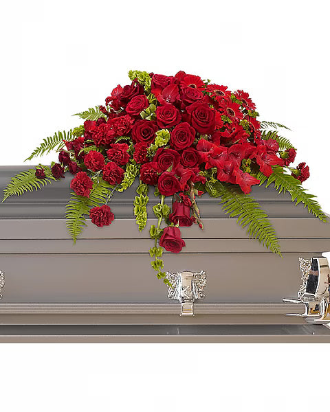 Grey casket adorned with red flowers