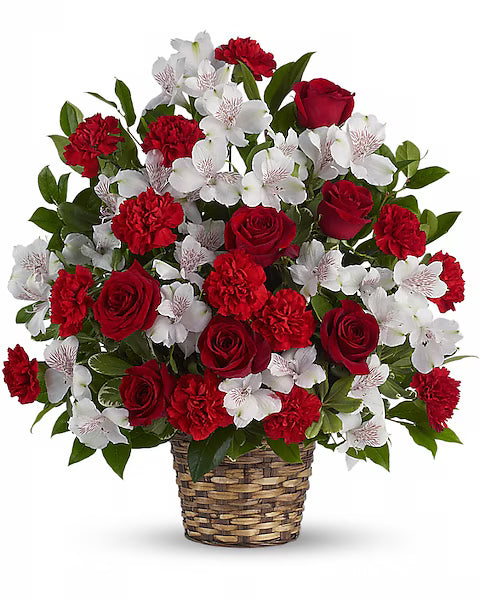Bouquet of red and white flowers in a woven basket